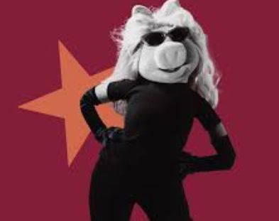 Miss Piggy character in all black with shades, defiant stance