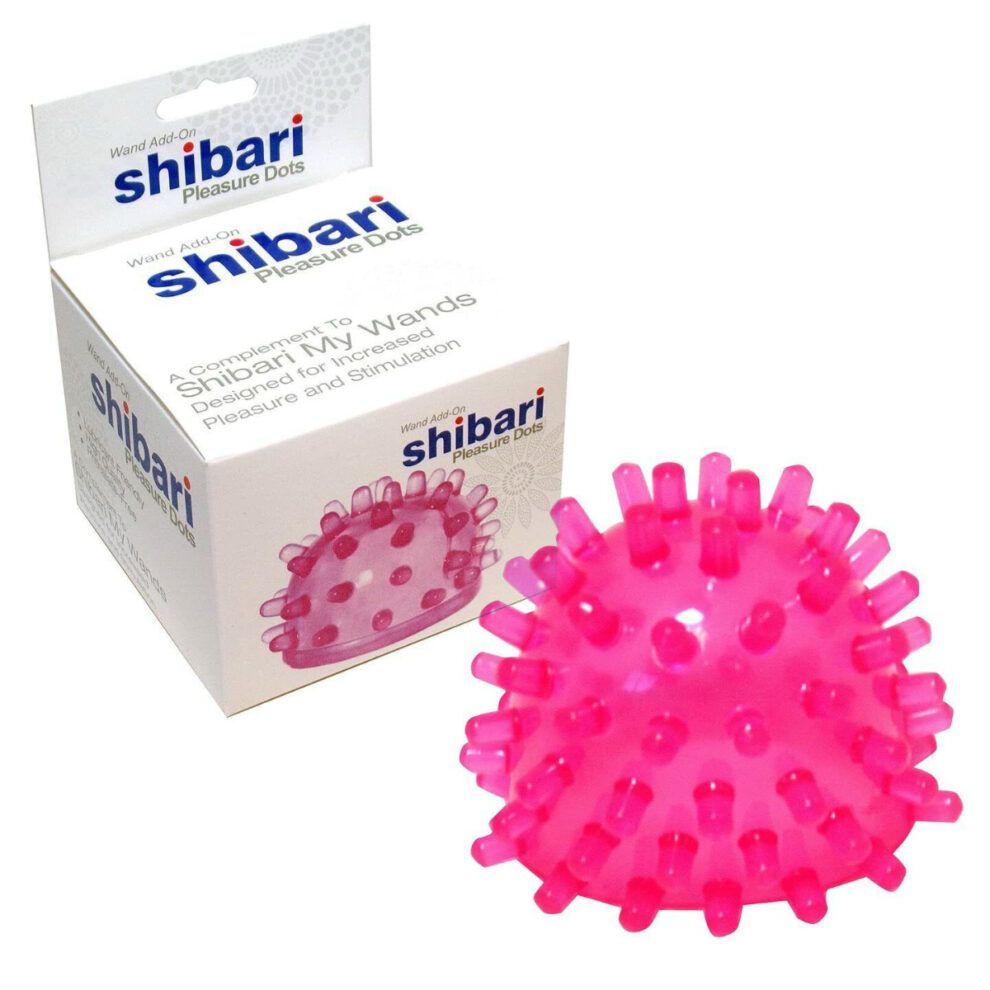 Box and end cap for a shibari wand. The cap for the wand is pink silicone with tiny pegs sticking up in all directions. The box says Shibari Pleasure Dots.