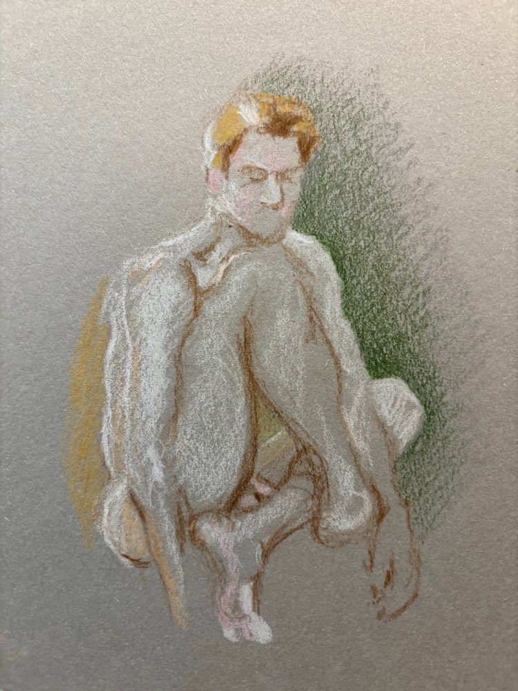 Male nude model with legs crossed on the floor