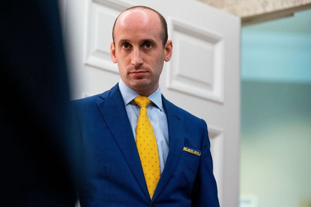 Stephen Miller, looking weird and creepy as ever, wearing a blue blazer and yellow tie.