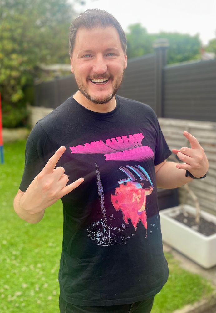 Smiling man wearing a Black Sabbath t shirt
