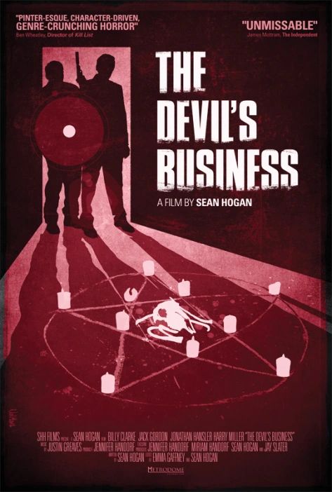 Poster for The Devil’s Business (2011). Poster shows two men in a doorway looking into a room containing bones, candles and a pentagram.