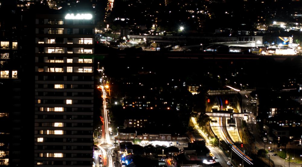Night shot of trains and roads leaving light trails 