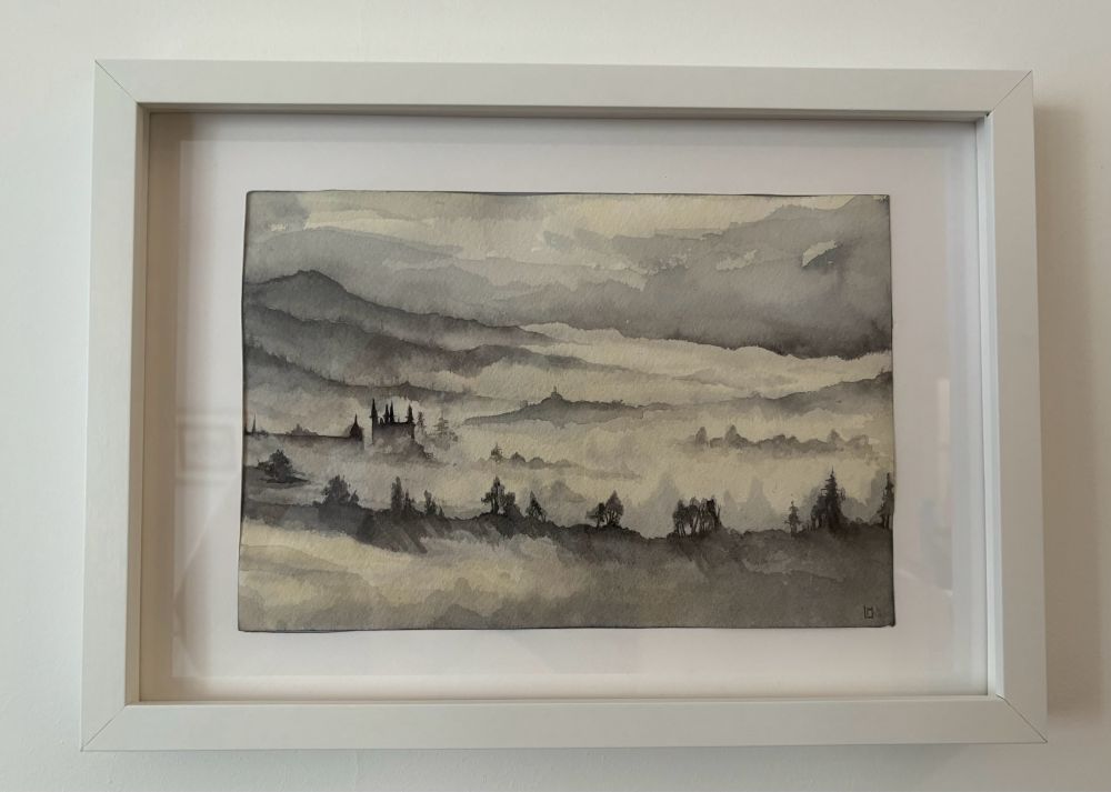 A watercolour of misty mountains with a few trees and a castle