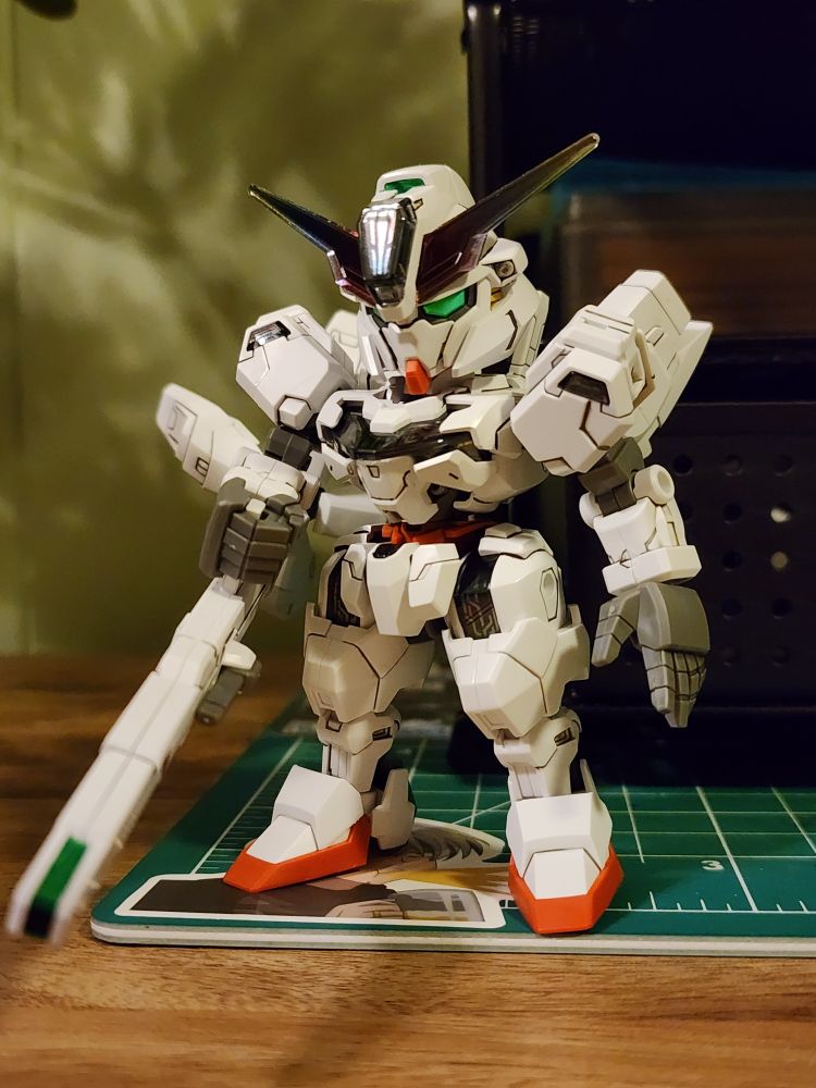 A SDCS model kit of the Gundam Calibarn from Mobile Suit Gundam The Witch from Mercury. The kit is holding its rifle in its right hand and is in a relaxed standing pose.