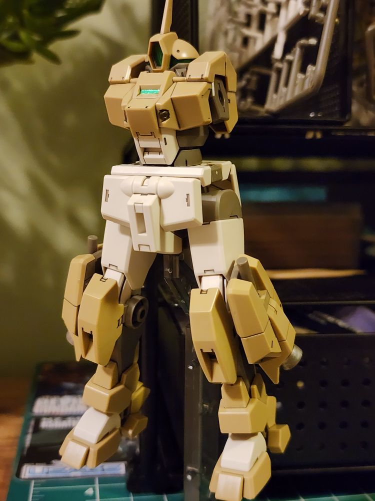 A partially completed HG Demi Barding model kit from Mobile Suit Gundam The Witch from Mercury. The kit is on an action base and in a neutral standing pose.