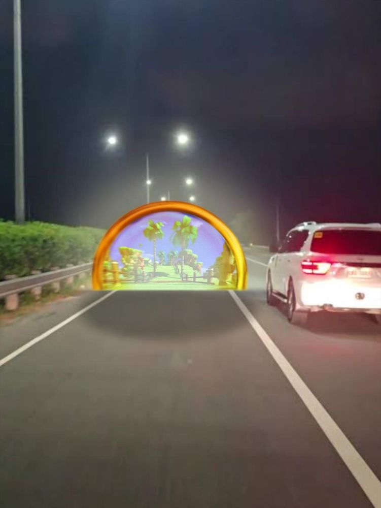 A photo of a highway at night with a warp ring / portal leading to Green Hill Zone halfway embedded into the ground. There is a white car beside the warp ring.