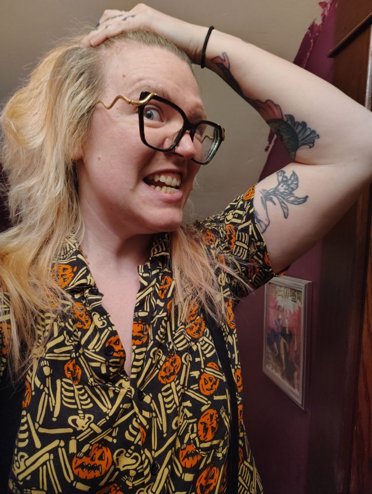 Another selfie of Ro but they have pulled back their bangs to reveal a widow's peak balding pattern.