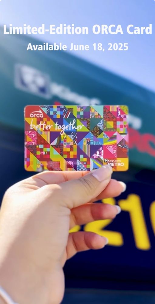 King County Metro “Better together” limited edition card is held up in front of a bus