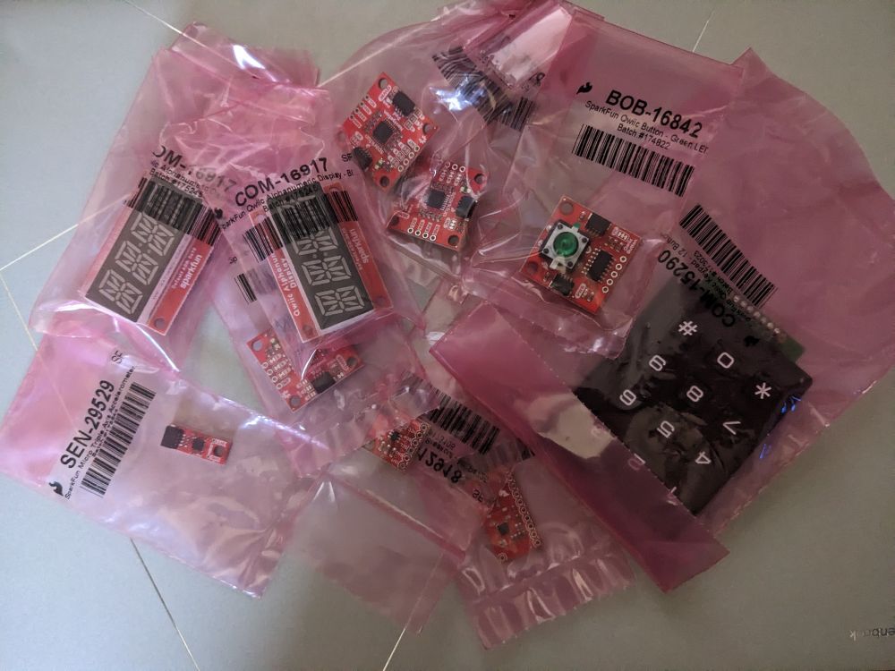 A pile of electronic parts on breakout boards from SparkFun.