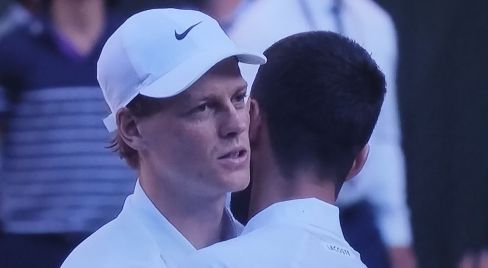 Sinner whispering in Djokovic's ear