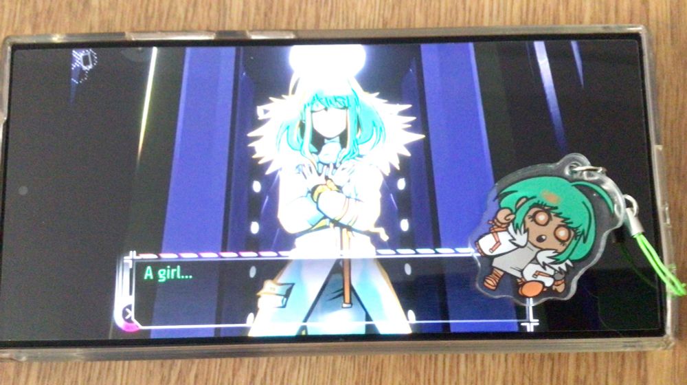 Serra phone charm displayed in front of a screen shot of her introduction
