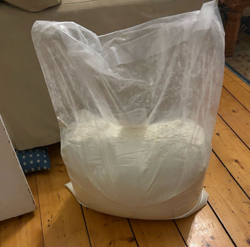 Large plastic sack of cake flour that will need a massive plastic crate to house 