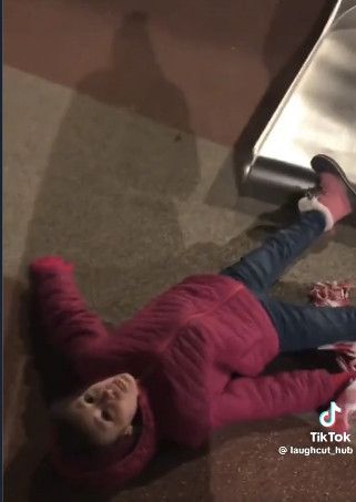 Person from final clip in the compilation, red parka and blue jeans, winter snow boots, they've just emerged from the slide and their eyes stare blankly into the sky. 