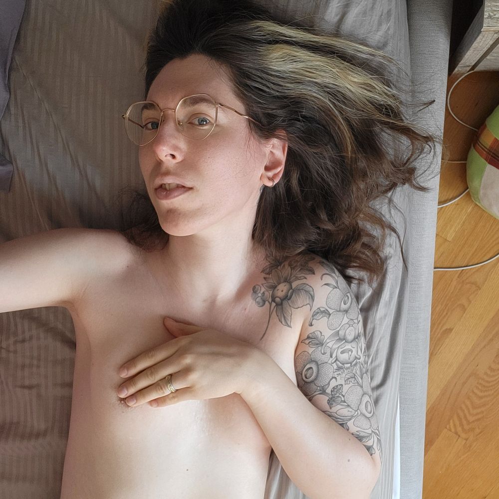 Dumb nude tattooed brunette laying on her bed.

She is covering her small breasts, her wedding band is visible but this picture is for you.

But this time it's a top view, look I just liked my hair ok.