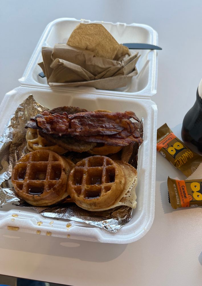 Pic of small waffles, bacon, sausage, a coke, and stay awake chocolate bites