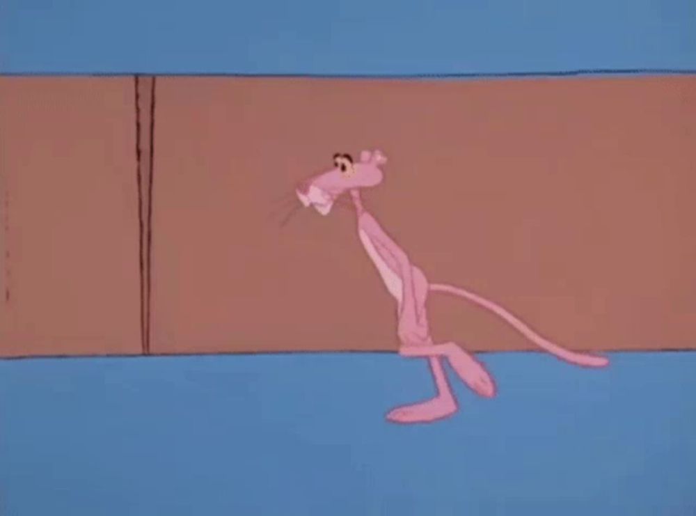 a pink panther is walking in front of a wooden wall in a cartoon .