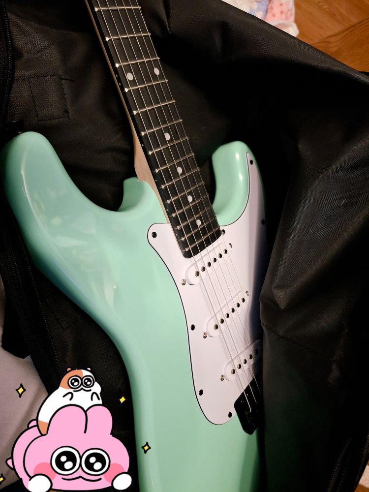 A mint green electric guitar that was a gift from my parents. 