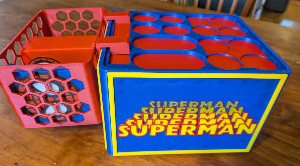 Opened view of case showing Superman logo on the bottom (intended to evoke the 70s movie using the same font)