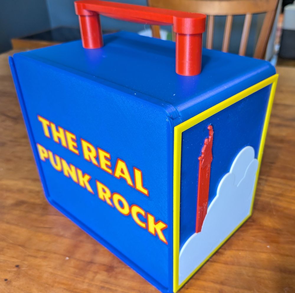Side view of case with the message "The Real Punk Rock" in Superman movie font.