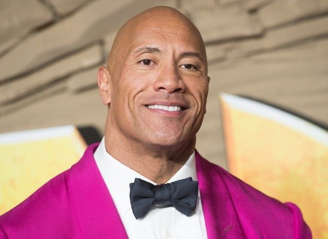 The Rock in pink suit and bowtie