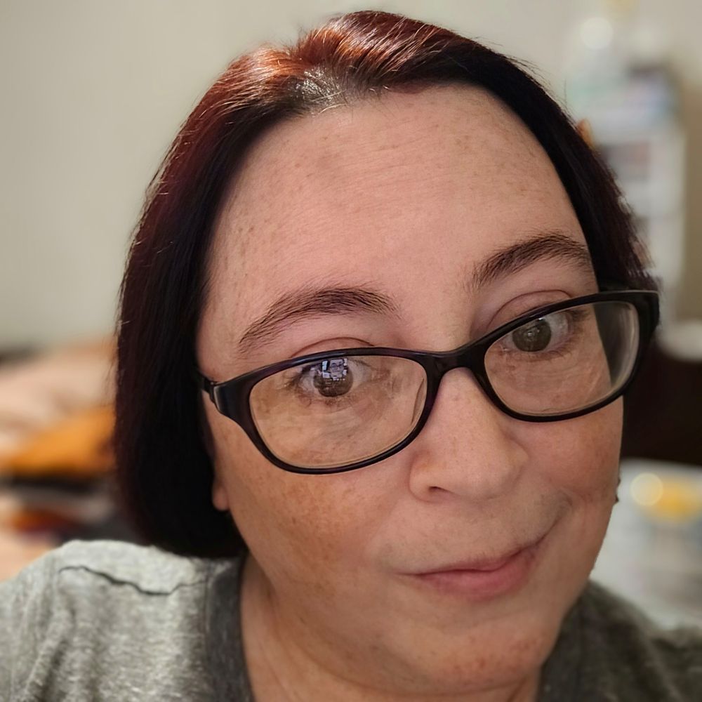 Selfie of me with my glasses on and freshly dyed red hair