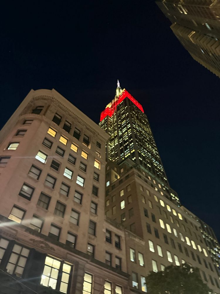 The Empire State Building, taken at an oblique angle from the street, with other buildings in front 