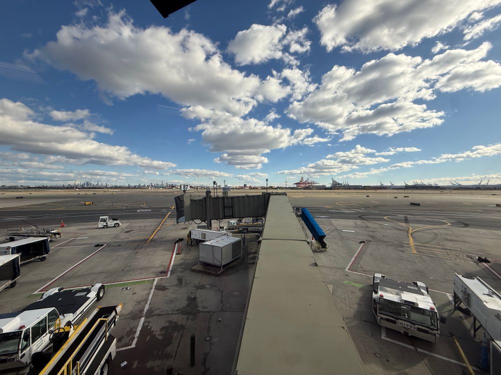 Vids of the tarmac in Newark airport. A jet bridge is in the foreground. New York City and port newark are in the background 