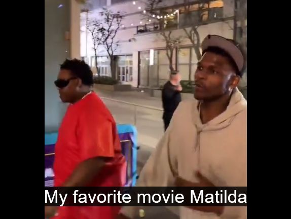 minnesota timberwolves guard anthony edwards walking around the la lakers arena after they won their 1st round playoff series mentions morris chestnut, an actor in the movie boyz n the hood, and gets asked by person filming if its his favorite movie, he replies, no "my favorite movie matilda". hes got a tan hoodie and a cap, walking next to security guy (presuming) in red shirt & sunglasses