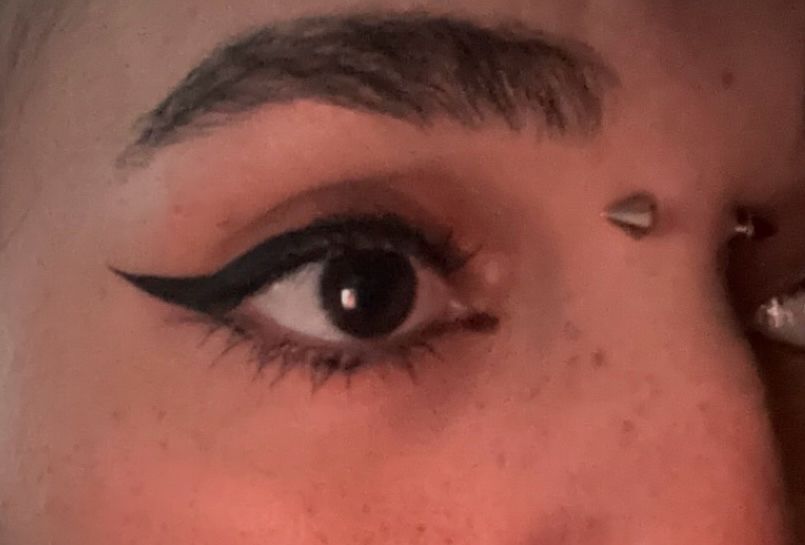 3/4 angle of a close up picture of my eye and my bridge piercing. 