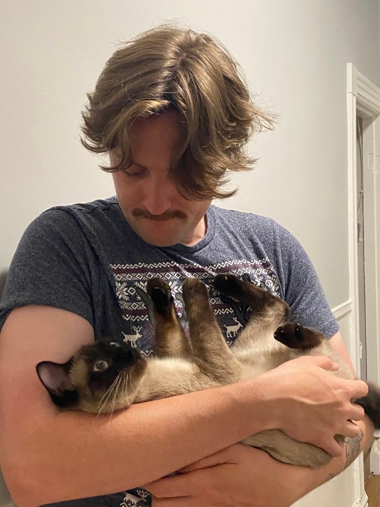 Robin holding my cat, Buttercup