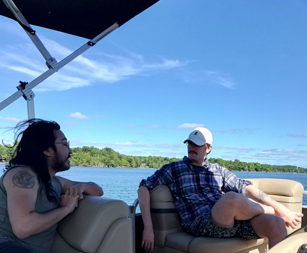 Robin and Kai sitting on a boat chatting