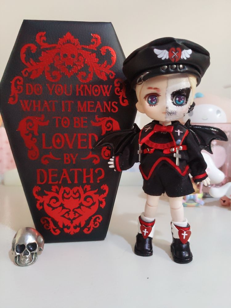 my darby doll, with the devil clothes, wearing a tiny hat.