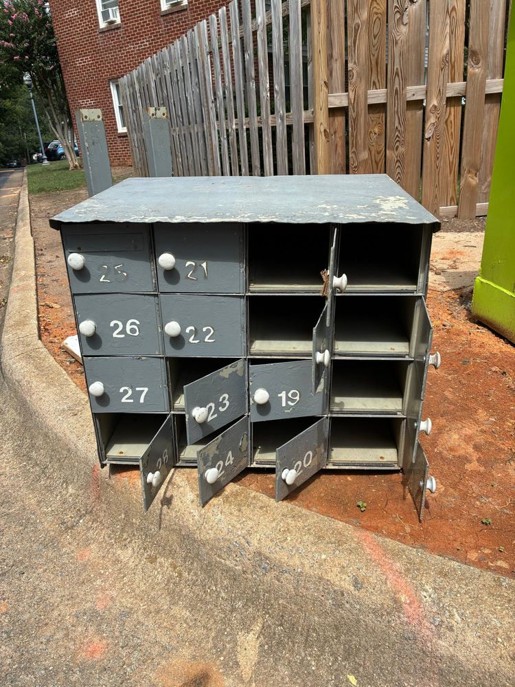 buncha haunted numbers at a dumpster its grey or blue