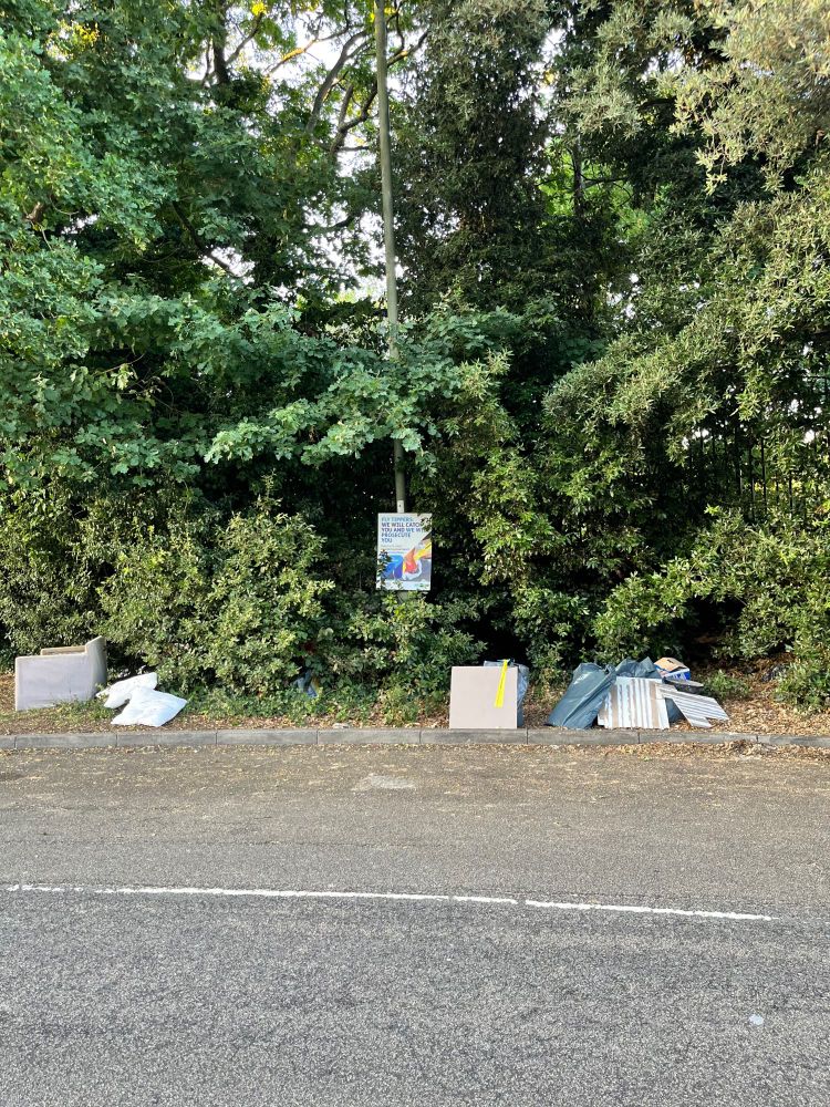 a sign warns flytippers that Barnet Council will find and prosecute them. This is right next to large piles of flytipped rubbish