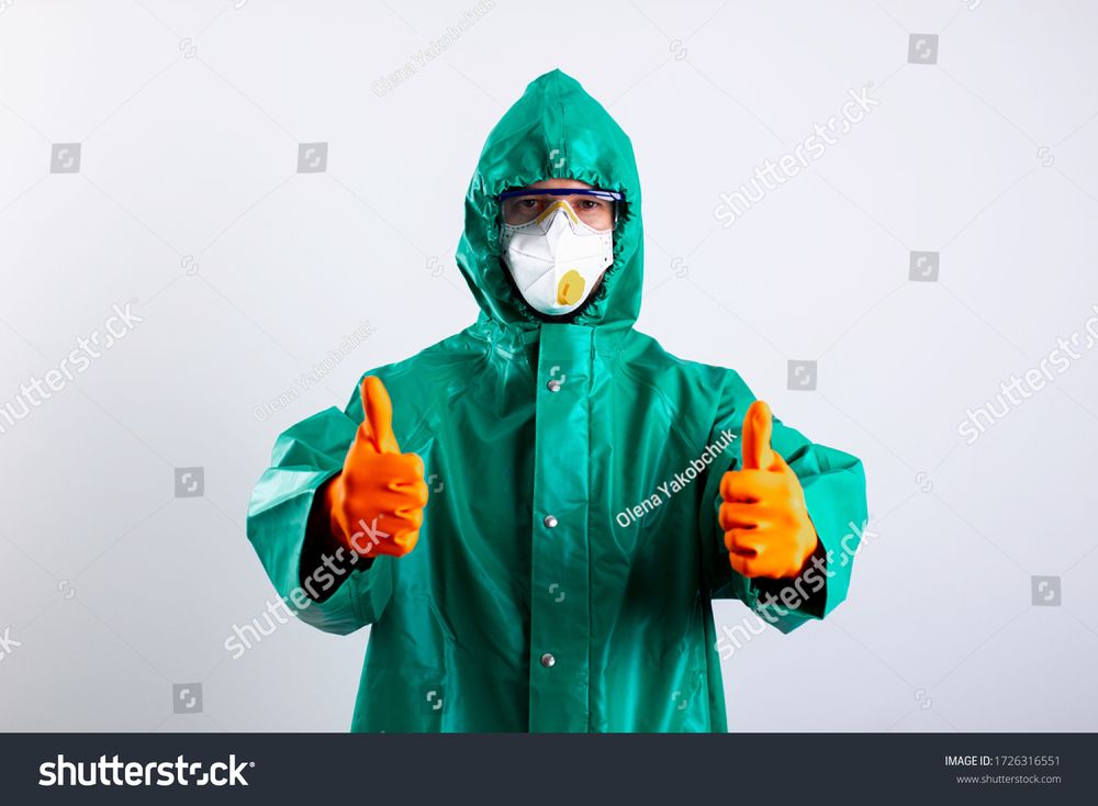 a stock image of a person in full hazmat gear giving two thumbs up