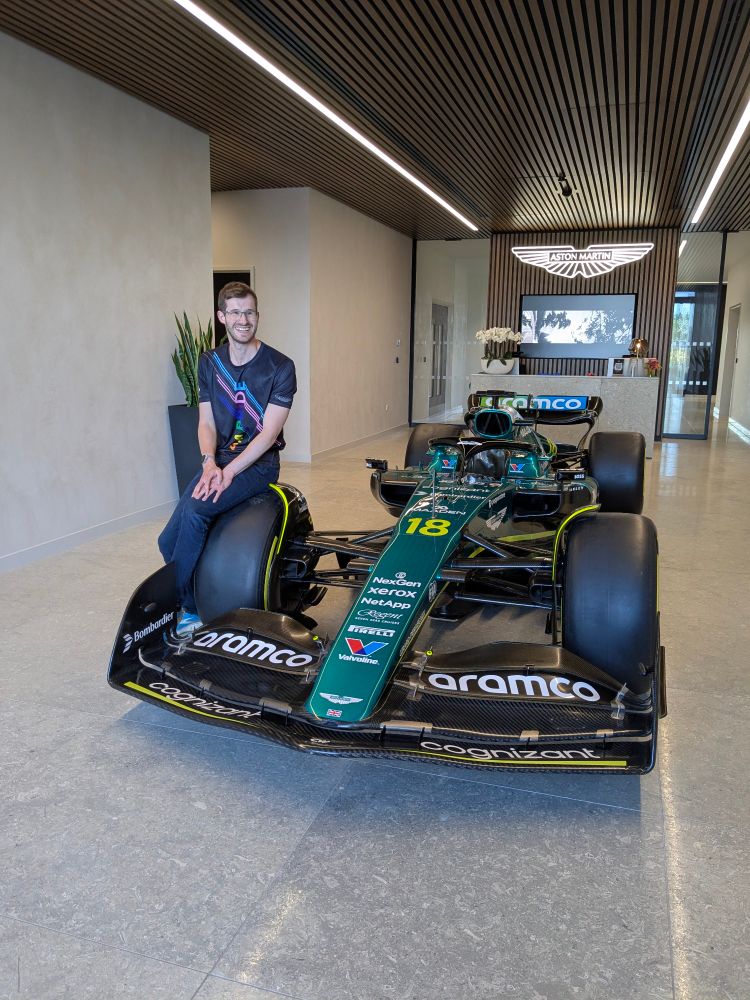 Me sitting on the wheel of the Aston Martin F1 car in their atrium.