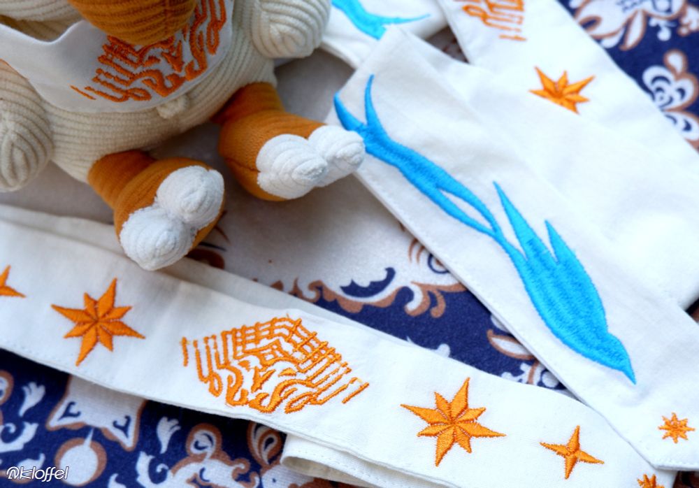 A closer look at the embroidered FFXIV Azem and Starbird designs.