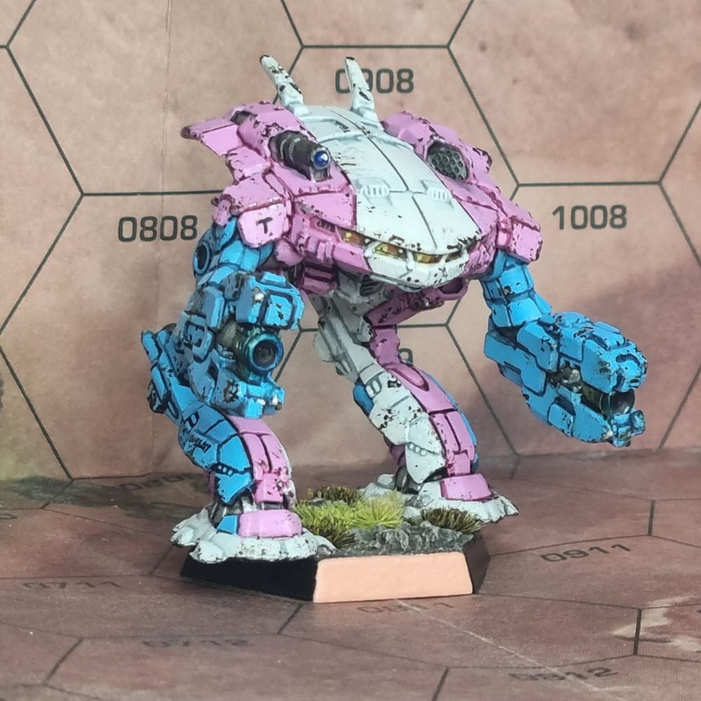 A battletech miniature of a King Crab battlemech painted in the blue, pink and white colours of the trans flag