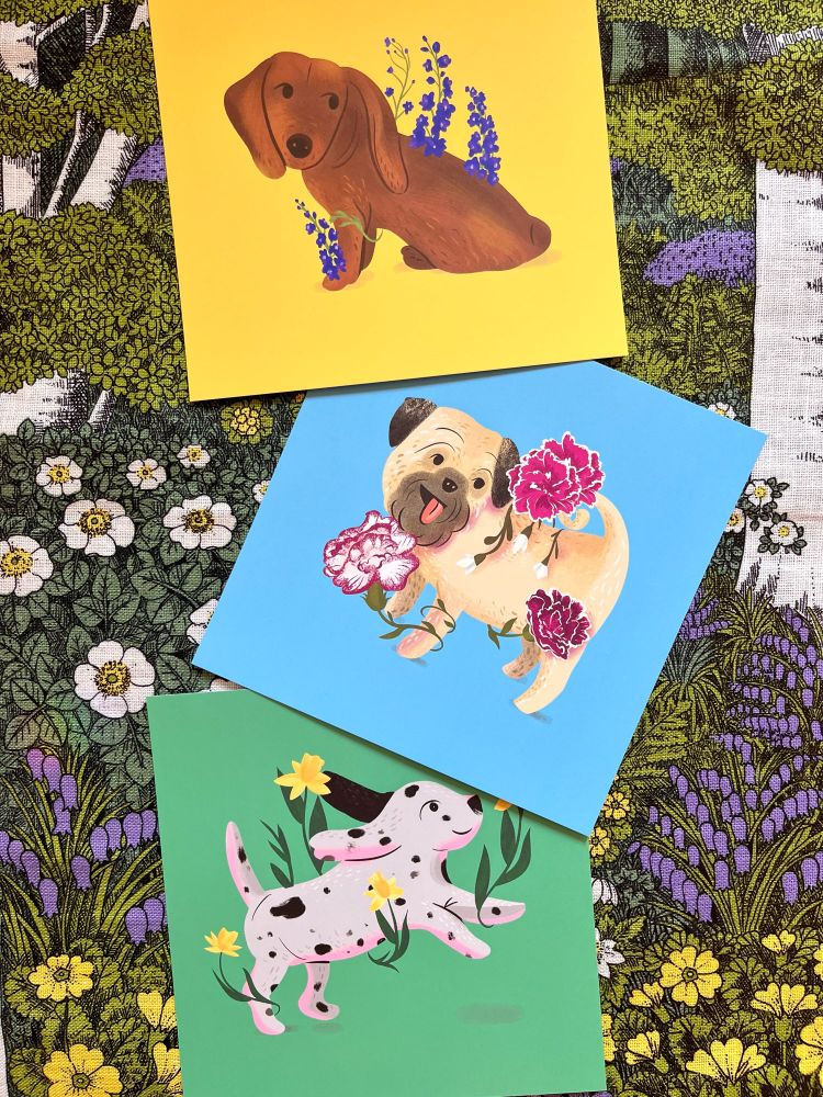 Art prints of a dachshund puppy, Dalmatian, and pug with flowers