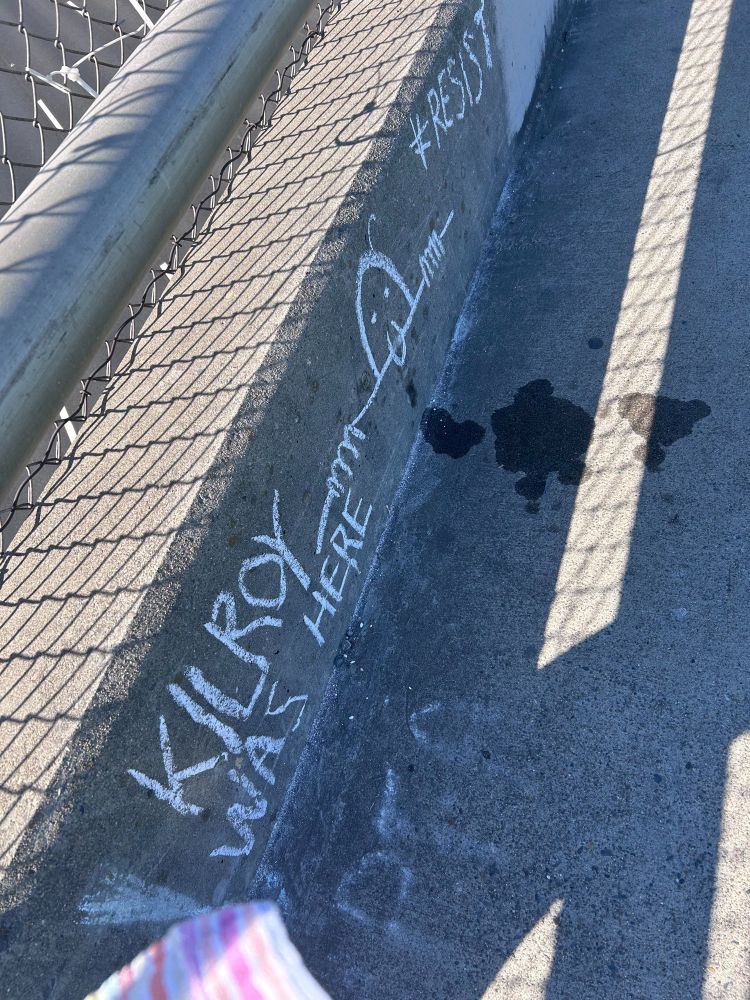 Chalk drawing of Kilroy Was Here taken at an overpass banner drop in Sacramento CA