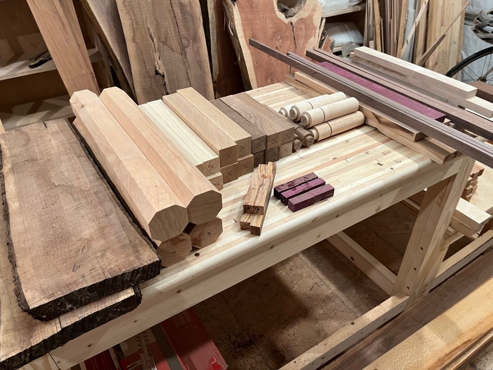 A workbench filled with wooden parts prepared for projects.