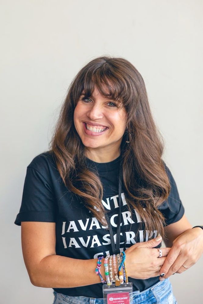 Photo of woman smiling in a tshirt that says anti JavaScript JavaScript club.