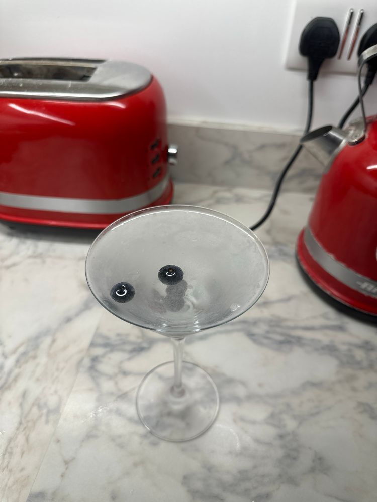 A picture of a blueberry martini.