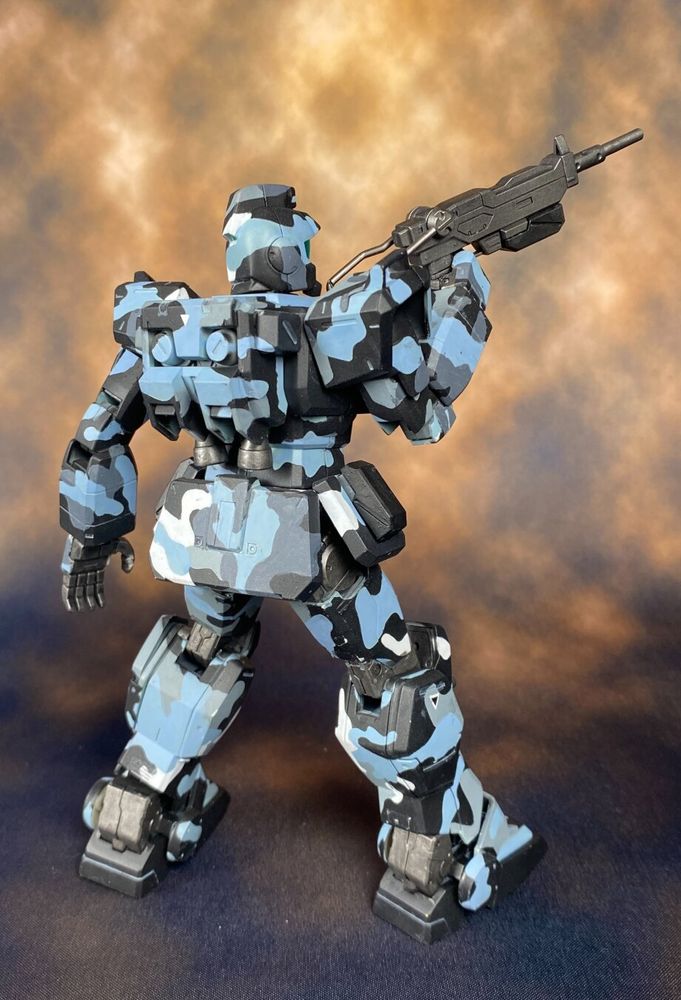 Model of a GM Ground Type in urban camouflage wielding a machine gun.
