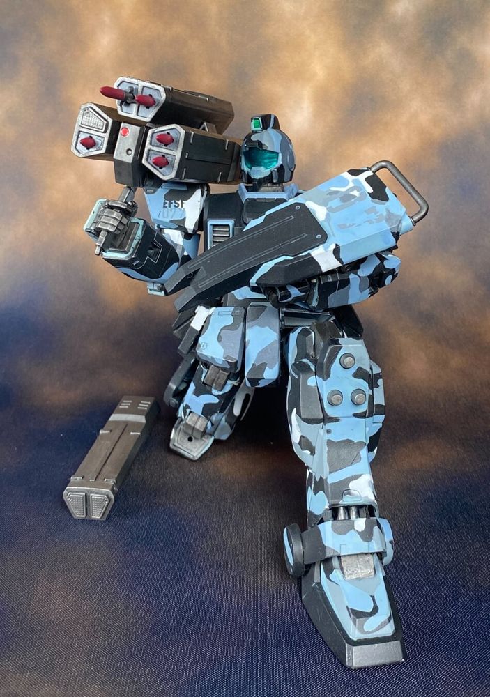 Model of a GM Ground Type in urban camouflage wielding a missile launcher.