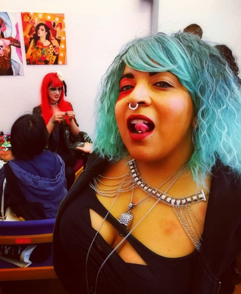 A cosplayer dressed as Persephone with The Morrigan in the background at a local event at a con years ago.