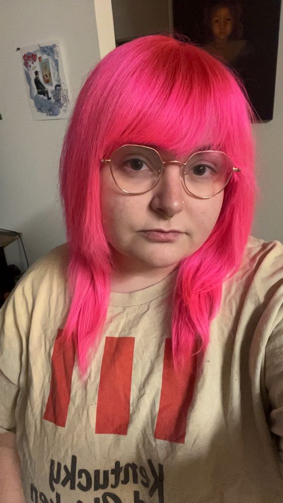 Girl with pink hair and glasses