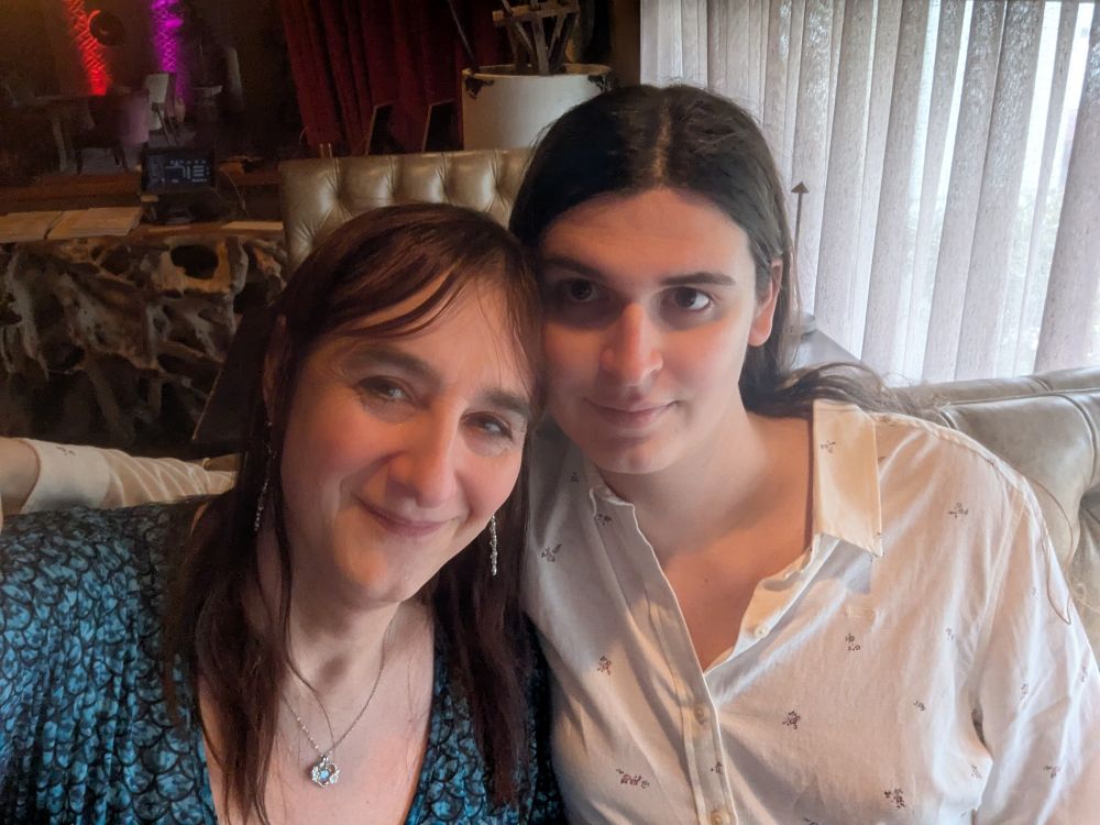 2 cute lasses sitting down to dinner in a restaurant