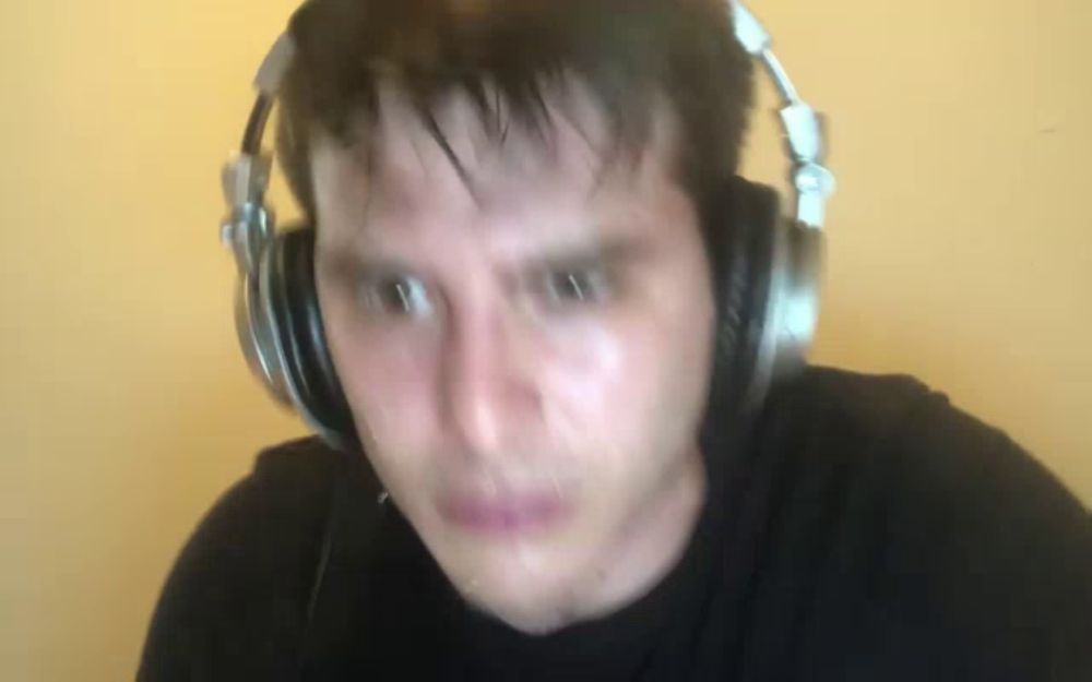 a man is wearing headphones and making a face